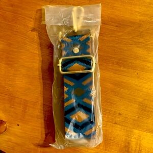 New in plastic Pom Pom London cross body strap.  Blue and Tan Diamond.